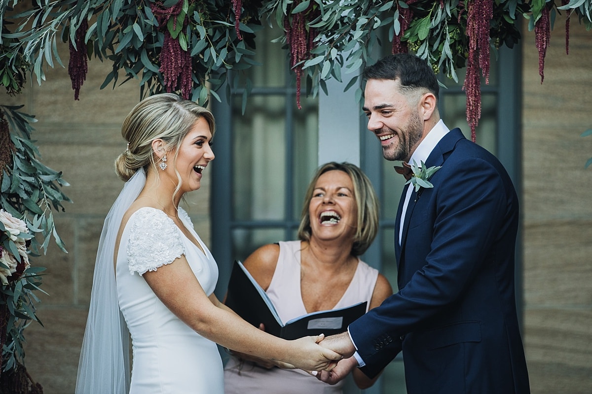 Bride and groom during their wedding ceremony in the sandstone courtyard at Gunners Barracks